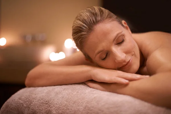 Basking in the afterglow of her massage. Cropped shot of a woman in a day spa relaxing on a massage table. — Stock Photo, Image