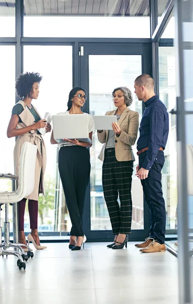 Great achievements are nurtured with the cooperation of many minds. Shot of a team of colleagues using modern technology during an informal meeting. — Stock Photo, Image