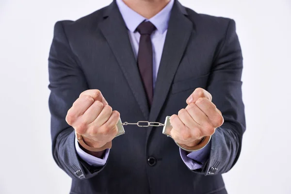 Ive made terrible decisions. Cropped studio shot of a businessman in handcuffs. Royalty Free Stock Photos