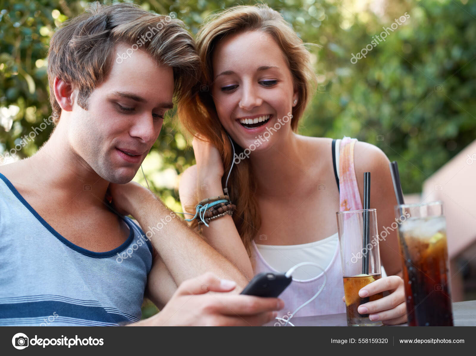 image-share.com cute tweens Socialising in the twenty first century. Cute teen couple sharing an MP3  player and listening to music while enjoying their beverages. — Stock Photo  © PeopleImages.com #558159320