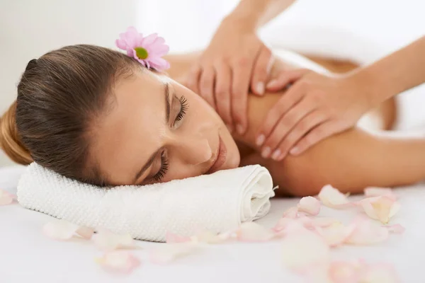 Taking time out for her weekly massage. Cropped shot of a gorgeous young woman enjoying a massage. Royalty Free Stock Images