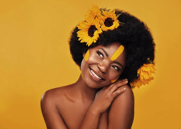 Nem választanék más virágot. Stúdió lövés egy gyönyörű fiatal nő mosolyog, miközben pózol napraforgóval a hajában ellen mustár háttér. — Stock Fotó