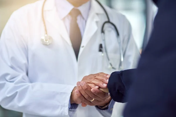 There is always hope. Cropped shot of a doctor holding a patients hand in comfort. — Stock Photo, Image
