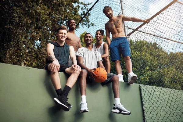Νιώθουμε σαν στο σπίτι μας στο γήπεδο. Πορτρέτο μιας ομάδας νεαρών αθλητών που αράζουν σε γήπεδο μπάσκετ. — Φωτογραφία Αρχείου