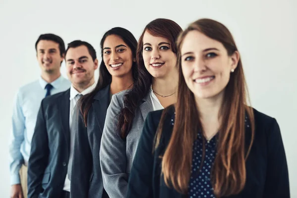 One team with one goal, success. Studio shot of a group of confident young businesspeople standing together in a row. — Stock Photo, Image