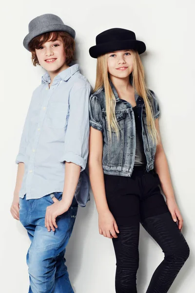 Never too young to look trendy. Portrait of two young kids posing in studio. — Stock Photo, Image