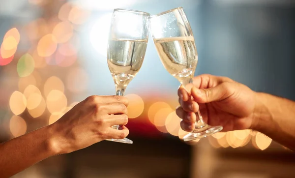 Theres always time for champagne. Shot of two unrecognizable people having champagne during a celebration. — Stock Photo, Image