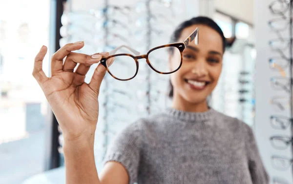 Zdvihněte brýle na dobré zdraví očí. Zastřelen mladou ženu, jak si kupuje nové brýle v obchodě s optometristy. — Stock fotografie