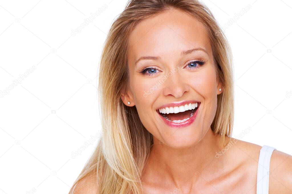 Her positive outlook is so attractive. A gorgeous young woman laughing while isolated on white.