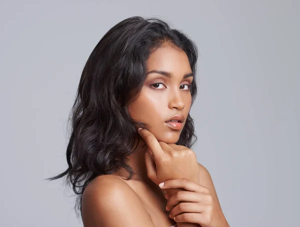 All natural beauty. Shot of a beautiful young posing over a gray background. — Stock Photo, Image