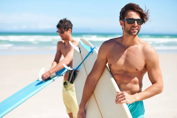 Surft auf. Zwei Freunde am Strand bereiten sich darauf vor, zum Surfen ins Wasser zu gehen. — Stockfoto
