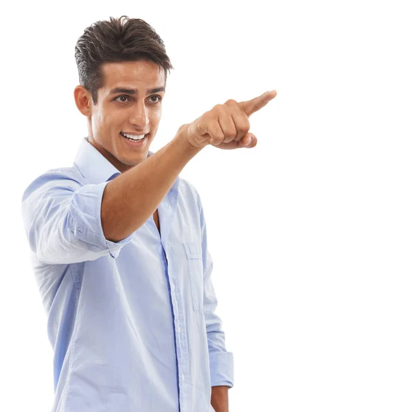 A mostrar-te o caminho. Um jovem bonito apontando o dedo e sorrindo contra um fundo branco. — Fotografia de Stock