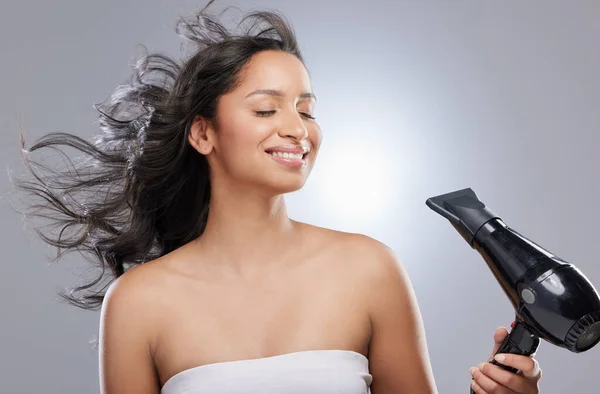 I lati positivi di essere una bruna sono chiari. Studio shot di una bella giovane donna che si asciuga i capelli. — Foto Stock