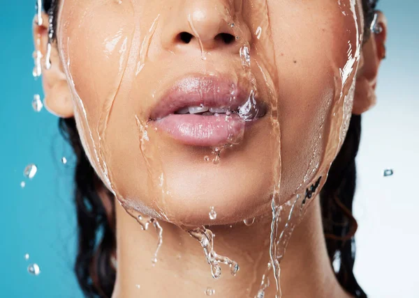 Sentirse energizado gracias al agua corriente. Foto recortada de una mujer irreconocible posando sobre un fondo azul mientras toma una ducha. — Foto de Stock