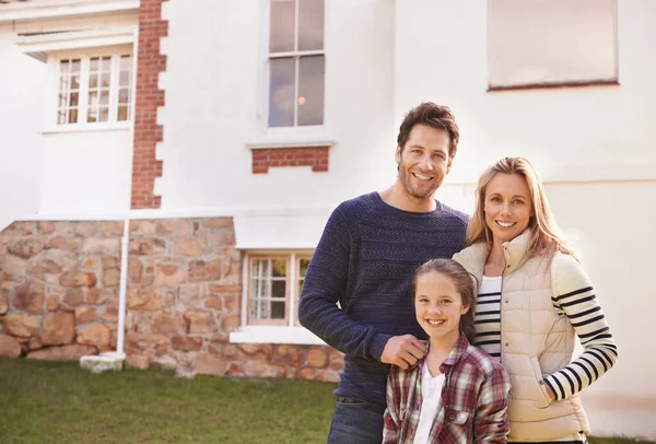 Zuhause süße Heimat. Porträt einer glücklichen Familie, die vor ihrem Haus posiert. — Stockfoto