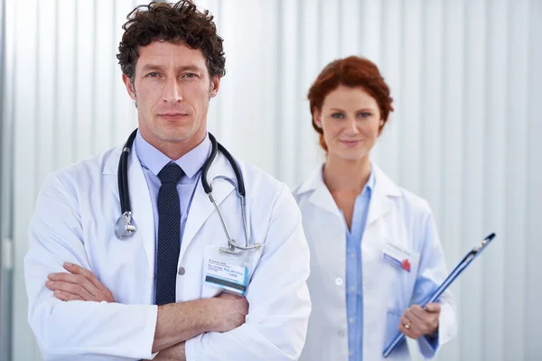 I hope weve made the right diagnosis. Cropped shot of two doctors standing together at work. — Stock Photo, Image