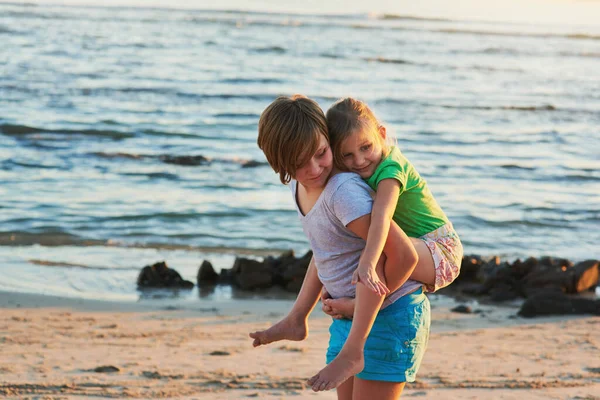 Summer days are best spent at the beach. Cropped shot of two young siblings enjoying the day together at the beach. — ストック写真