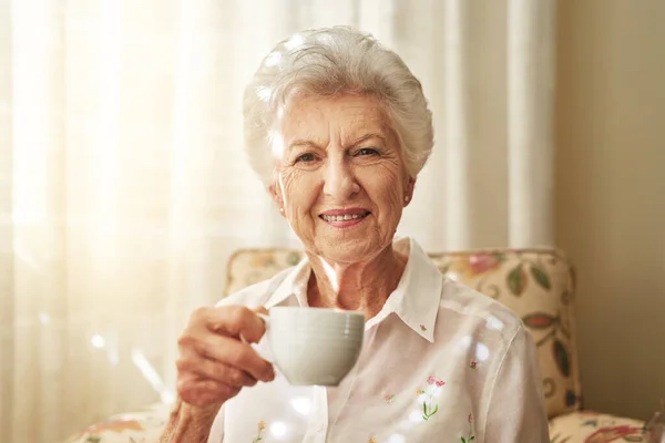 Sommige tradities worden nooit oud, zoals mijn kopje thee. Portret van een gelukkige oudere vrouw die thuis een kopje thee drinkt. — Stockfoto
