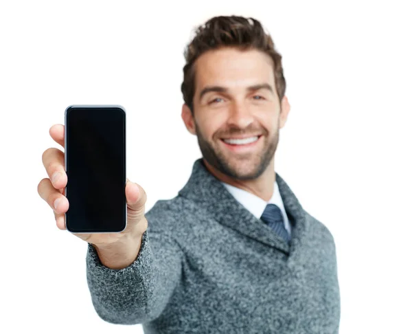 Este é o mais recente must-have novo aplicativo. Estúdio retrato de um empresário bonito mostrando um telefone com uma tela em branco contra um fundo branco. — Fotografia de Stock