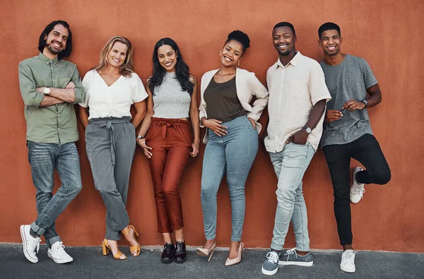 We dont stop until we win. Full length portrait of a diverse group of businesspeople standing together against a wall outside. — ストック写真