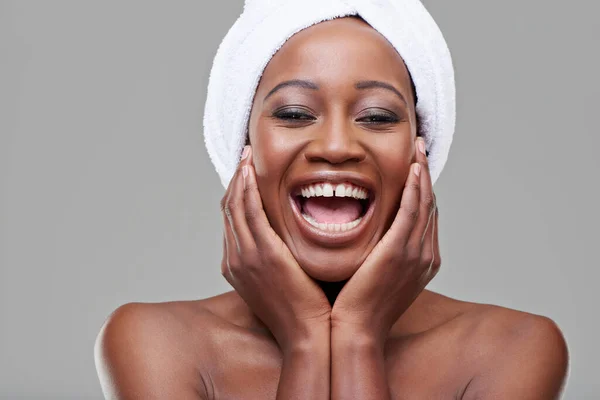 Strålande skratt. Studio skott av en ung kvinna med vacker hud att vara glad. — Stockfoto