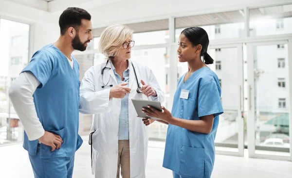 Vård av hög kvalitet handlar om att sätta patienten i centrum. Skjuten av en grupp läkare som diskuterar på sjukhus. — Stockfoto