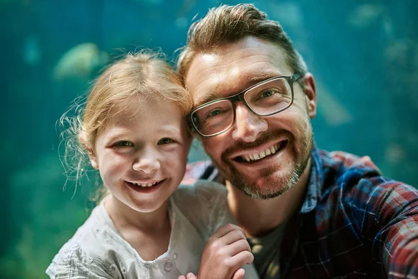 De ervaring voor altijd laten duren. Portret van een vader en zijn dochtertje die samen een selfie maken in een aquarium. — Stockfoto