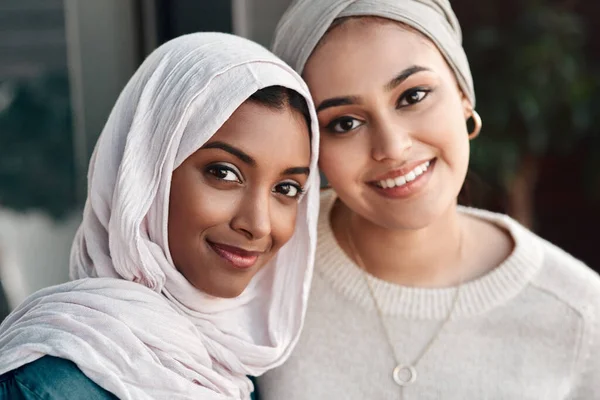 Onze weekenden gaan geweldig, dank je. Gesneden portret van twee aanhankelijke jonge vriendinnen die samen rondhangen in een café terwijl ze gekleed zijn in hijab. — Stockfoto