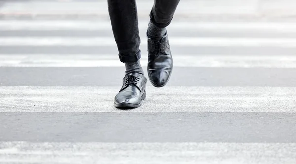 Even small steps can lead to greatness. Shot of an unrecognizable businessman crossing the street in the city. — ストック写真