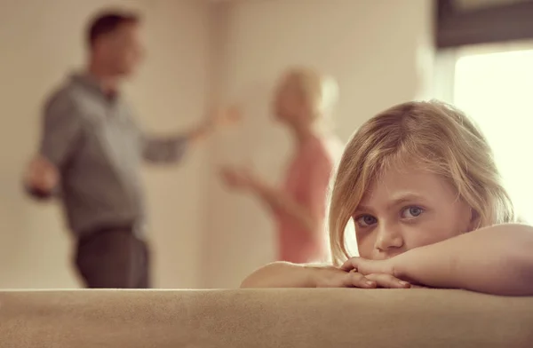 stock image Why do they have to fight. Shot of a little girl looking unhappy as her parents argue in the background.