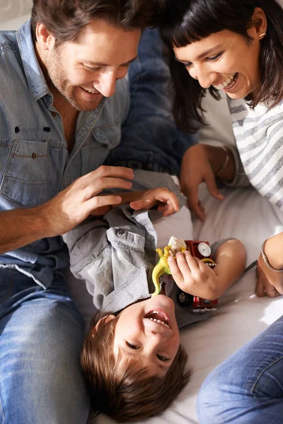 子供たちはあなたの人生に喜びを追加する特別な方法を持っています。幸せな両親が息子と一緒に家にいるときに. — ストック写真