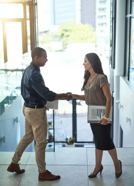 Well see success together. Shot of two businesspeople shaking hands in an office. — Stock Photo, Image