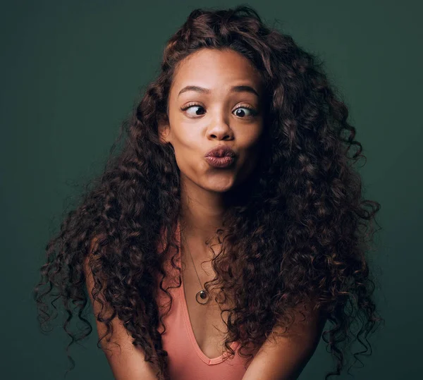 Pouting because Im pretty. Cropped shot of an attractive and quirky young woman posing against a green background in studio. — Stock Photo, Image