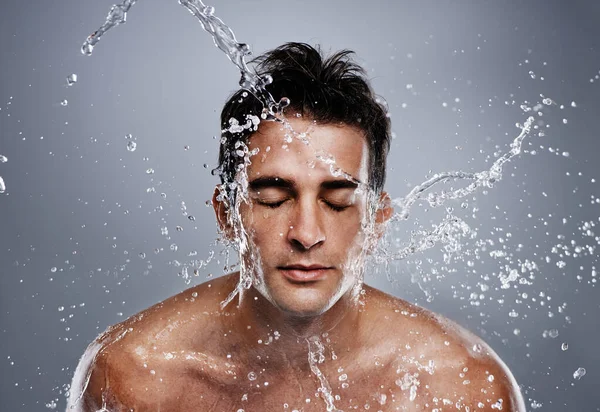 Temizleniyorum. Yüzüne su sıçrayan genç bir adam.. — Stok fotoğraf