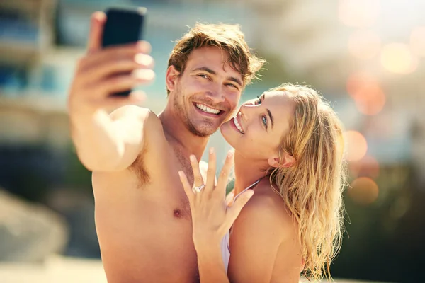 Adoro la mia fede nuziale. Ritagliato colpo di una giovane donna che mostra la sua fede nuziale mentre prende un selfie con il marito. — Foto Stock