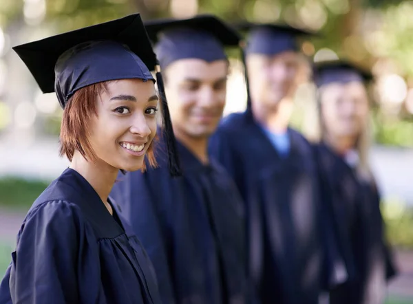 Excited for what is to come. A group of smiling graduates standing in a row and looking at the camera. — Stock Photo, Image