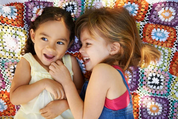 La primauté de l'enfance. Plan grand angle de deux petites filles allongées et jouant sur une couverture. — Photo