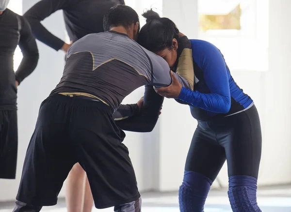 Visar henne några drag. Beskuren bild av en jiu jitsu sensei sparring med en av sina elever under en klass. — Stockfoto