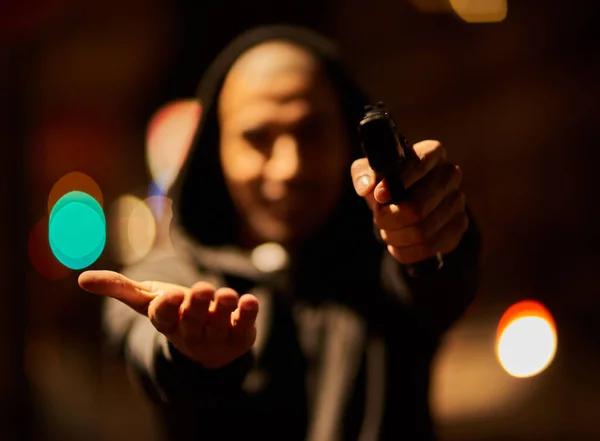 Your goods or your life. Shot of a gun-wielding thief aiming his weapon. — Stock Photo, Image