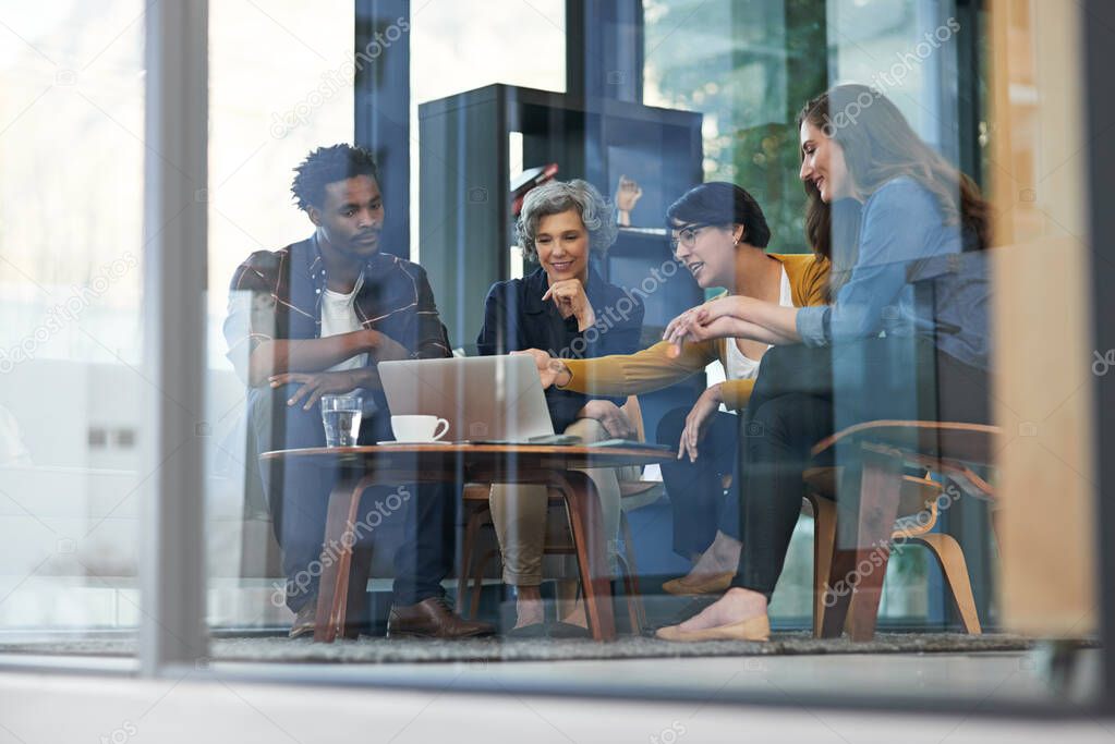 Their success is the product of meticulous planning. Shot of a team of creative businesspeople brainstorming around a laptop in the office.