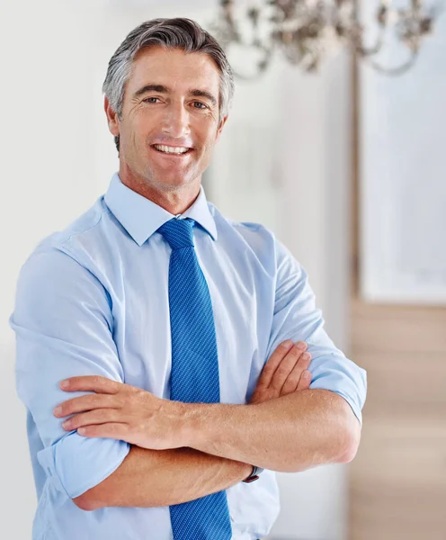 Doing business is what I excel at. Portrait of a smiling mature businessman standing with his arms crossed. — ストック写真