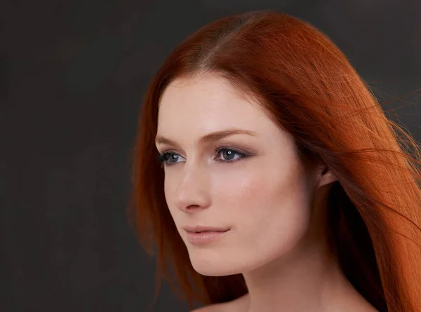 True beauty. Studio shot of a gorgeous young redheaded woman against a black background. — ストック写真