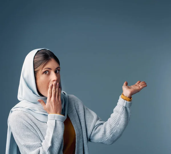 This one took me by surprise. Cropped portrait of an attractive young woman endorsing your product while standing against a grey background. — ストック写真