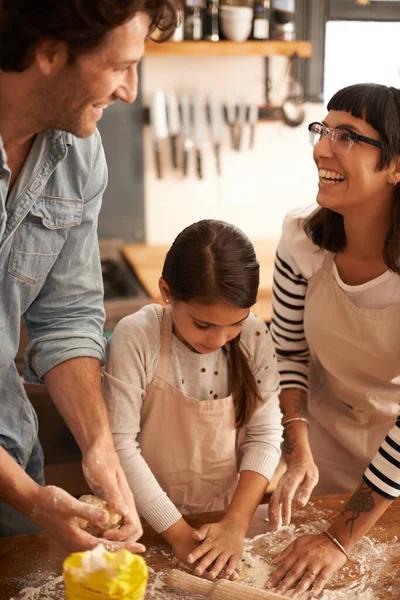 Making biscuits and memories in the kitchen. Shot of a family having fun baking in a kitchen. — ストック写真