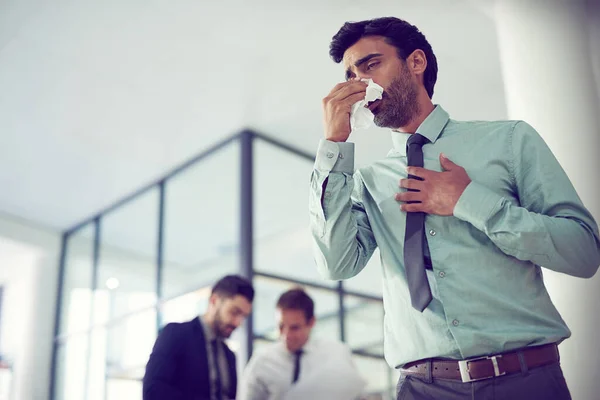 Feeling groggy with flu. Cropped shot of a businessman suffering with allergies in an office. — Stock Photo, Image
