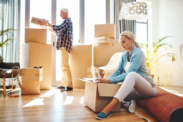 Erinnerungen einpacken. Aufnahme eines reifen Paares beim Packen von Kisten am Umzugstag. — Stockfoto