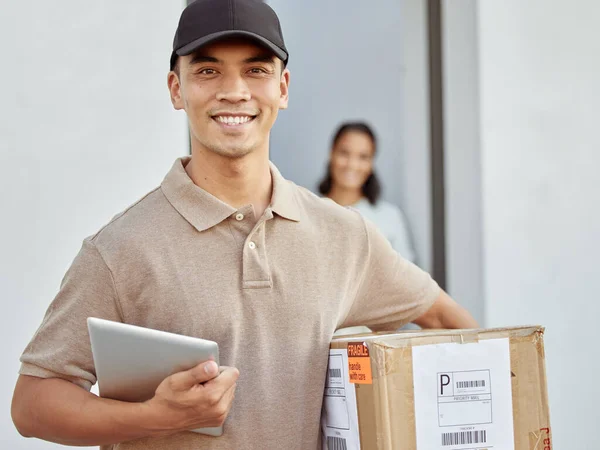 Proud to bring customers their packages. Shot of a young delivery man delivering packages to a customer.