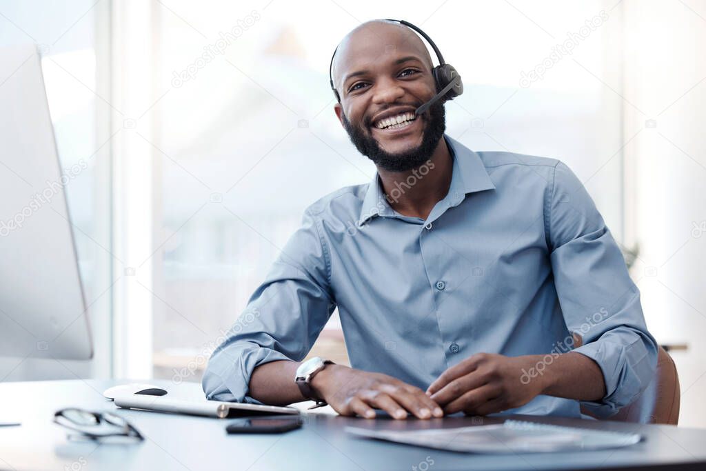 Come to me with problems and Ill give you a solution. Cropped portrait of a handsome young male call center agent working on his computer in the office.