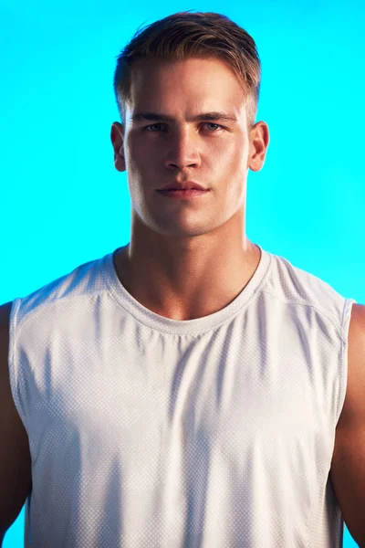 Its all about the will to win. Studio portrait of a handsome young male athlete posing against a blue background. — ストック写真