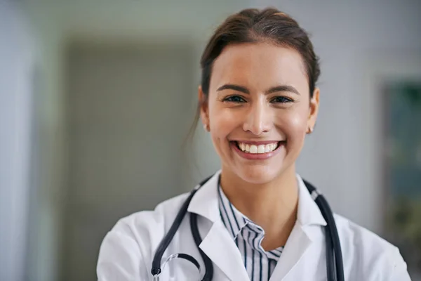 The smile that puts every patient at ease. Portrait of a cheerful young doctor at work. — ストック写真